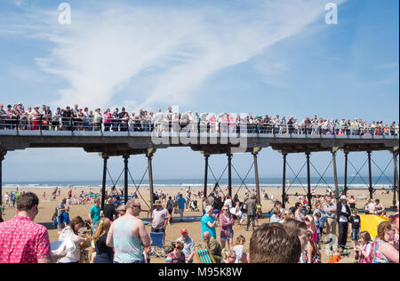 People on Saltburn`s Victorian pier under a blue sky in summer. Saltburn by the sea, North Yorkshire, England. UK Stock Photo